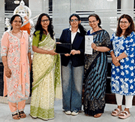 Photo of Angel Gandhi (centre).